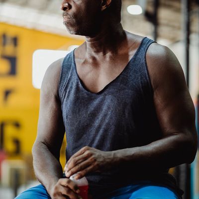 Person drinking water and resting after an intense workout.